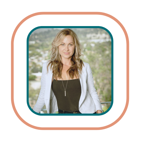 Trembo founder Courtney Sanders in black shirt and white blazer standing outside looking at camera confidently.