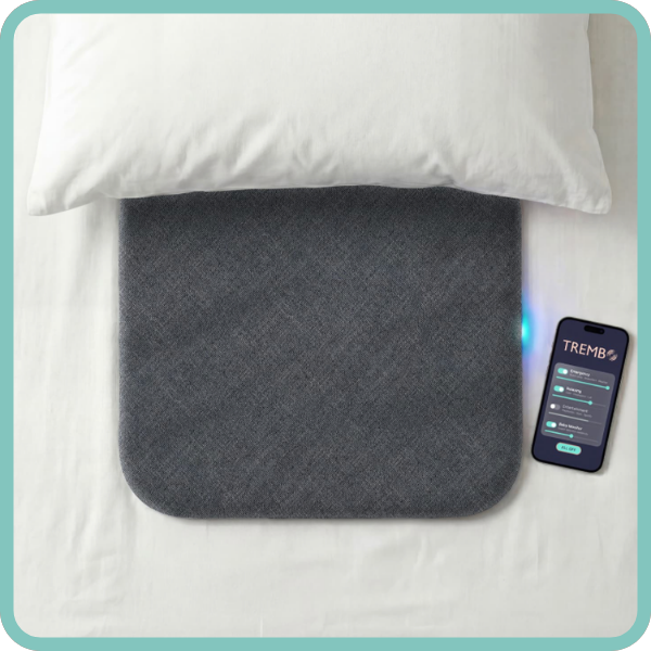 A thin, square pad under a pillow with a smartphone displaying an app with customization options.
