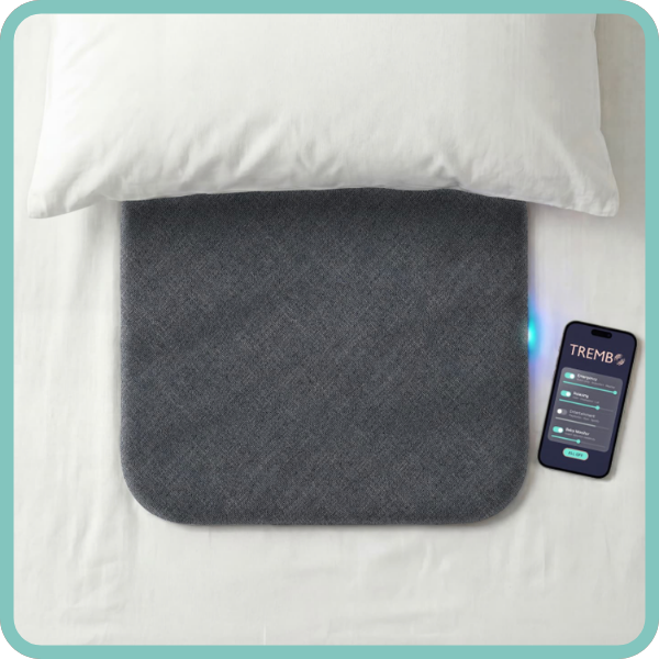 AI-generated image of a thin gray Trembo pad under a pillow next to a cell phone with the Trembo app visible