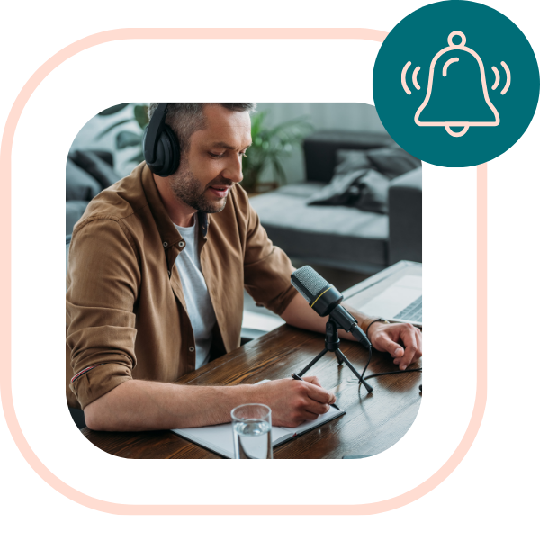 Middle aged dad sits on his Trembo at desk with a microphone