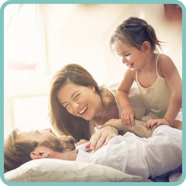 Image of relaxed mother, father and toddler happy and safe in bed with Tremo.