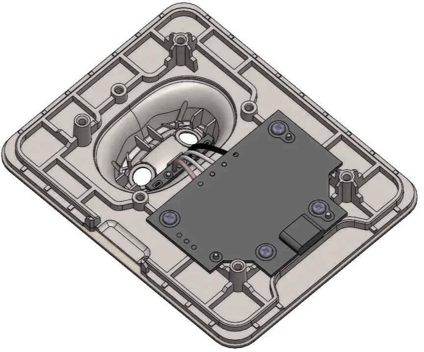 A device with internal electronic components and wiring, enclosed in a light-colored plastic casing.