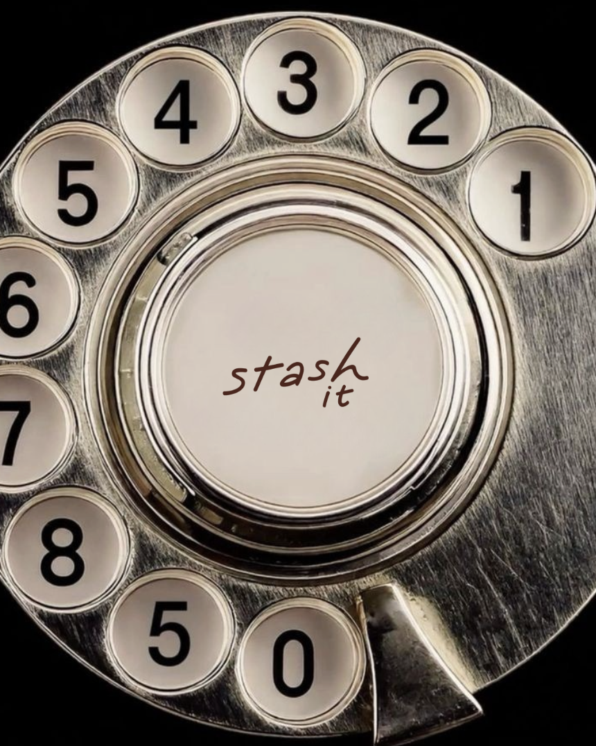 A vintage rotary phone with a circular dial displaying the numbers 0 through 8, and the phrase 'stash it' written in the center.