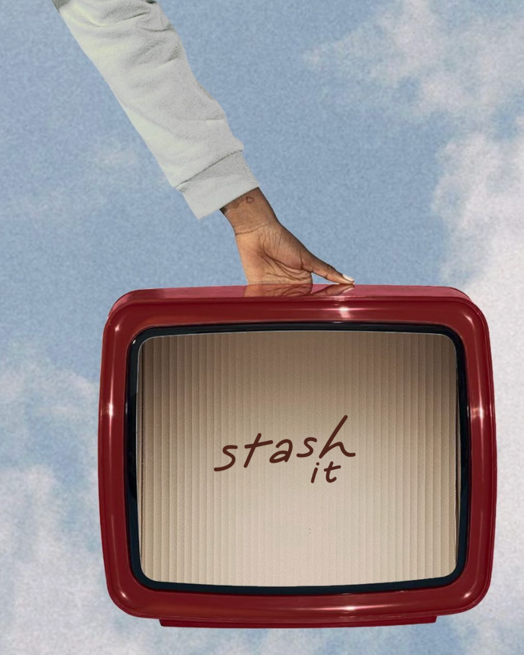 A hand reaching down from above, touching a red vintage television set with a message on the screen that says 'stash it', against a background of blue sky with white clouds.