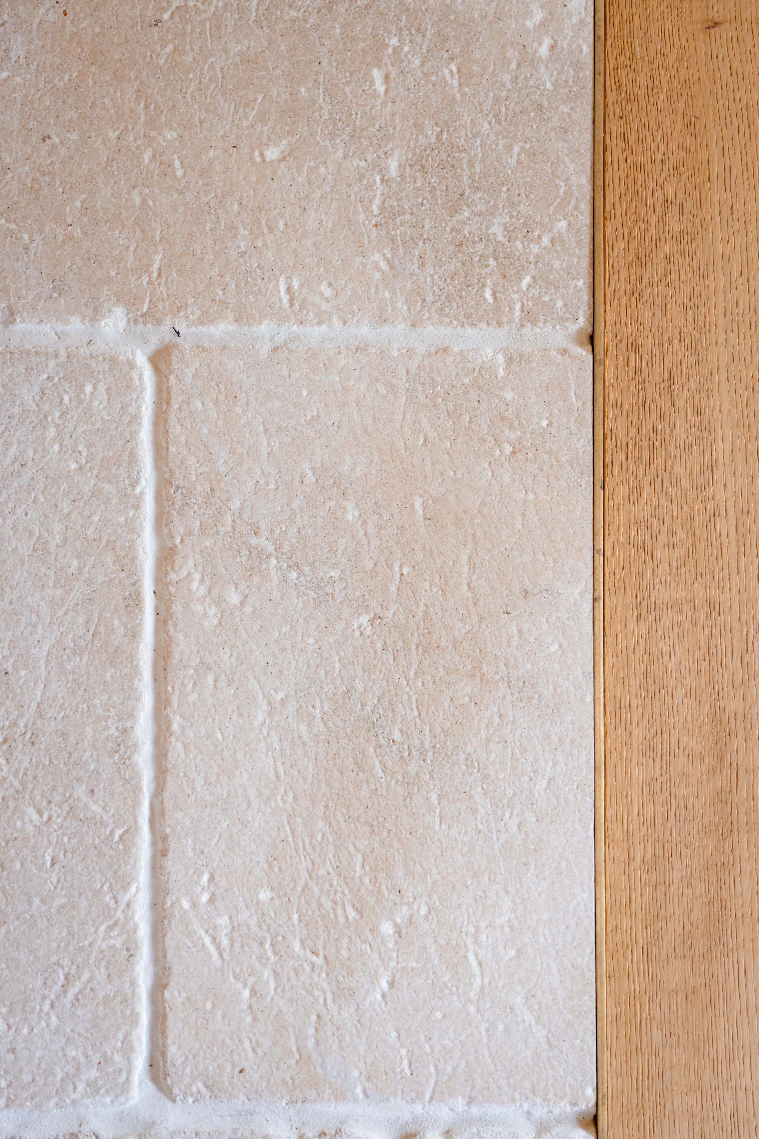 Close-up of limestone tile flooring used in a straw bale house renovation in New Paltz, NY.