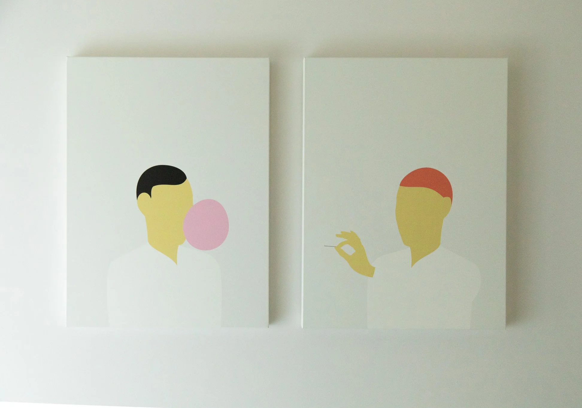 Two minimalist framed art prints displayed side by side on a light wall.