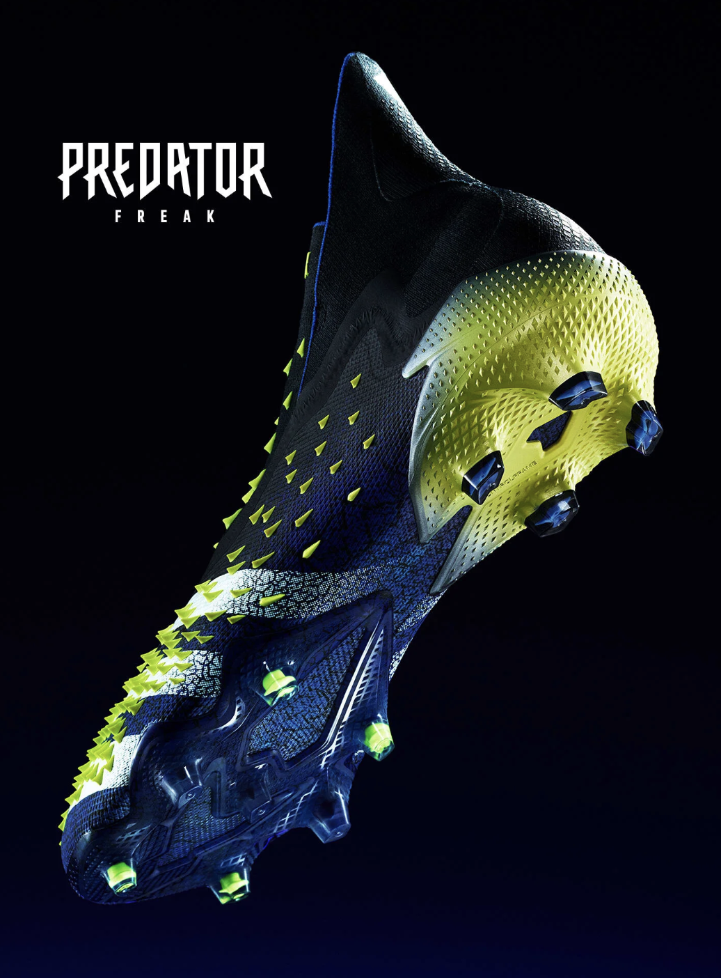 A futuristic black and yellow Nike soccer cleat with a textured sole and blue accents, displayed against a dark background, with the text "Predator Freak" in the top left corner.