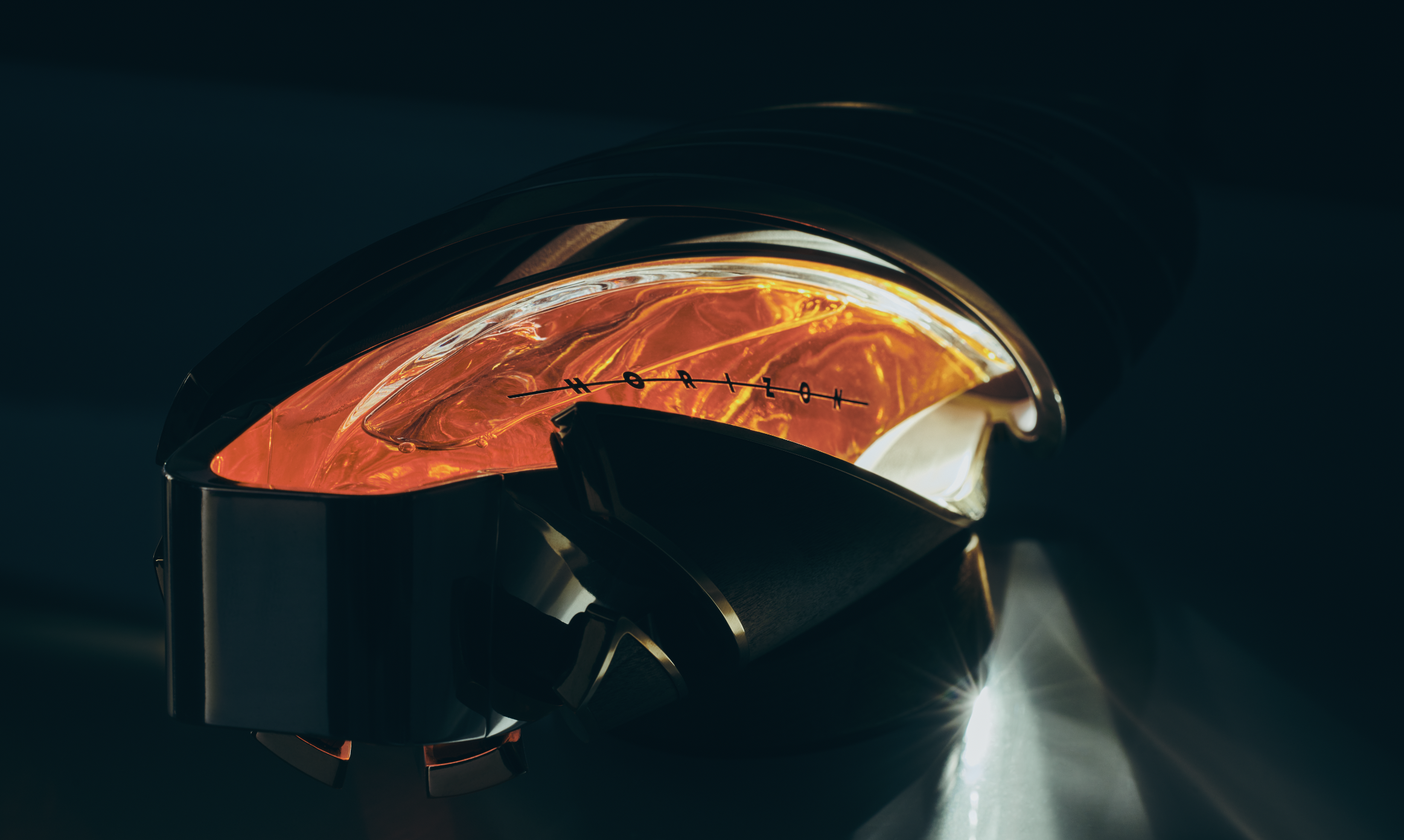 Close-up of the headlamp of a motorcycle with an orange glow and a distinctive measurement scale.