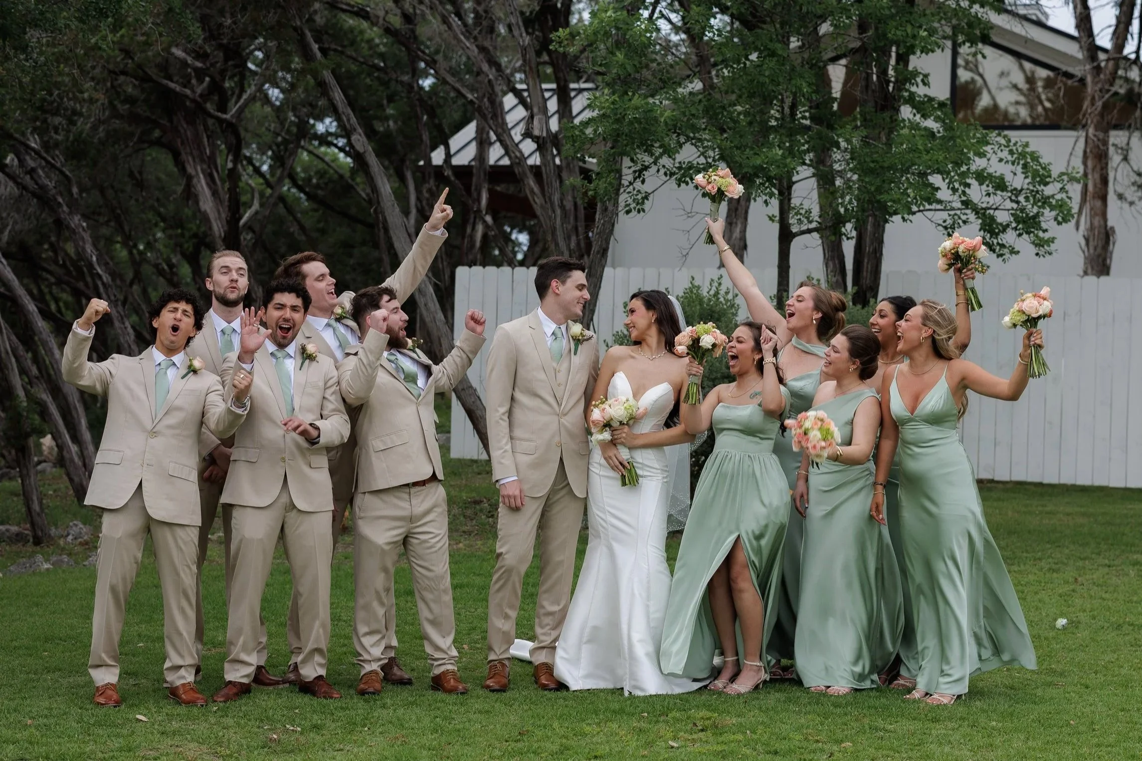 Group shot of a bridal party with bride and groom center at the Videre Estate in Wimberly, Texas