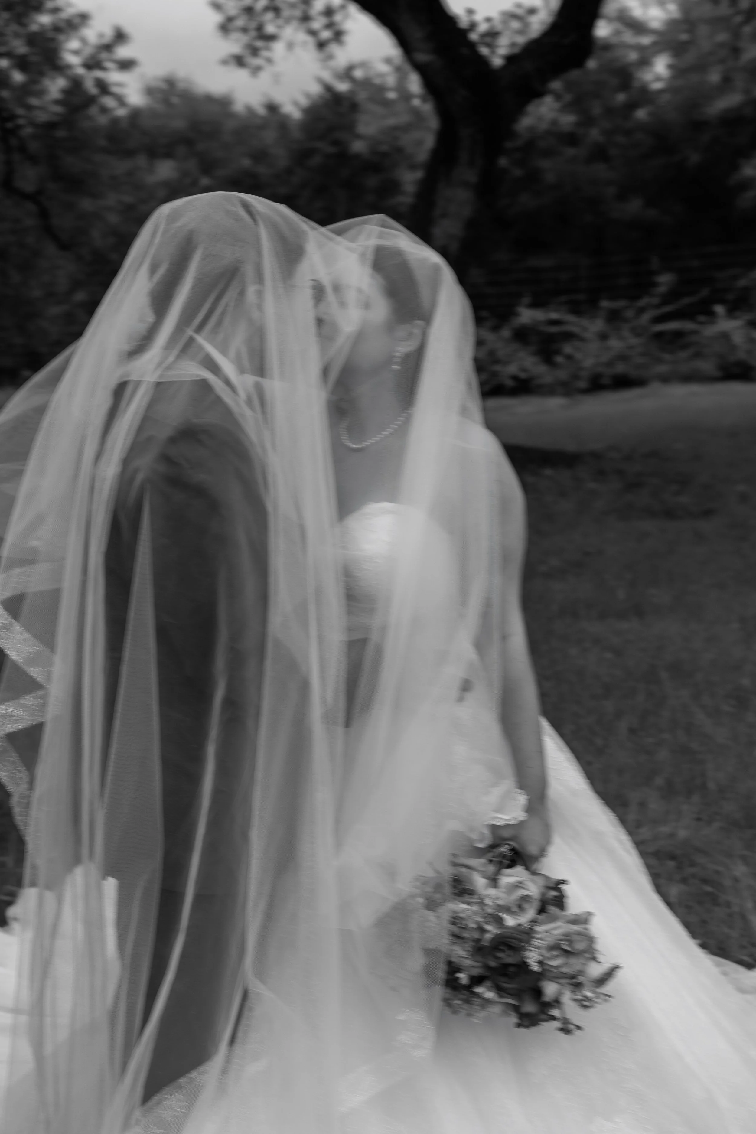 Editorial and cinematic posed photo of a bride and groom doing couples bridal photos after their ceremony at the beautiful venue, The Arlo, in Austin Texas
