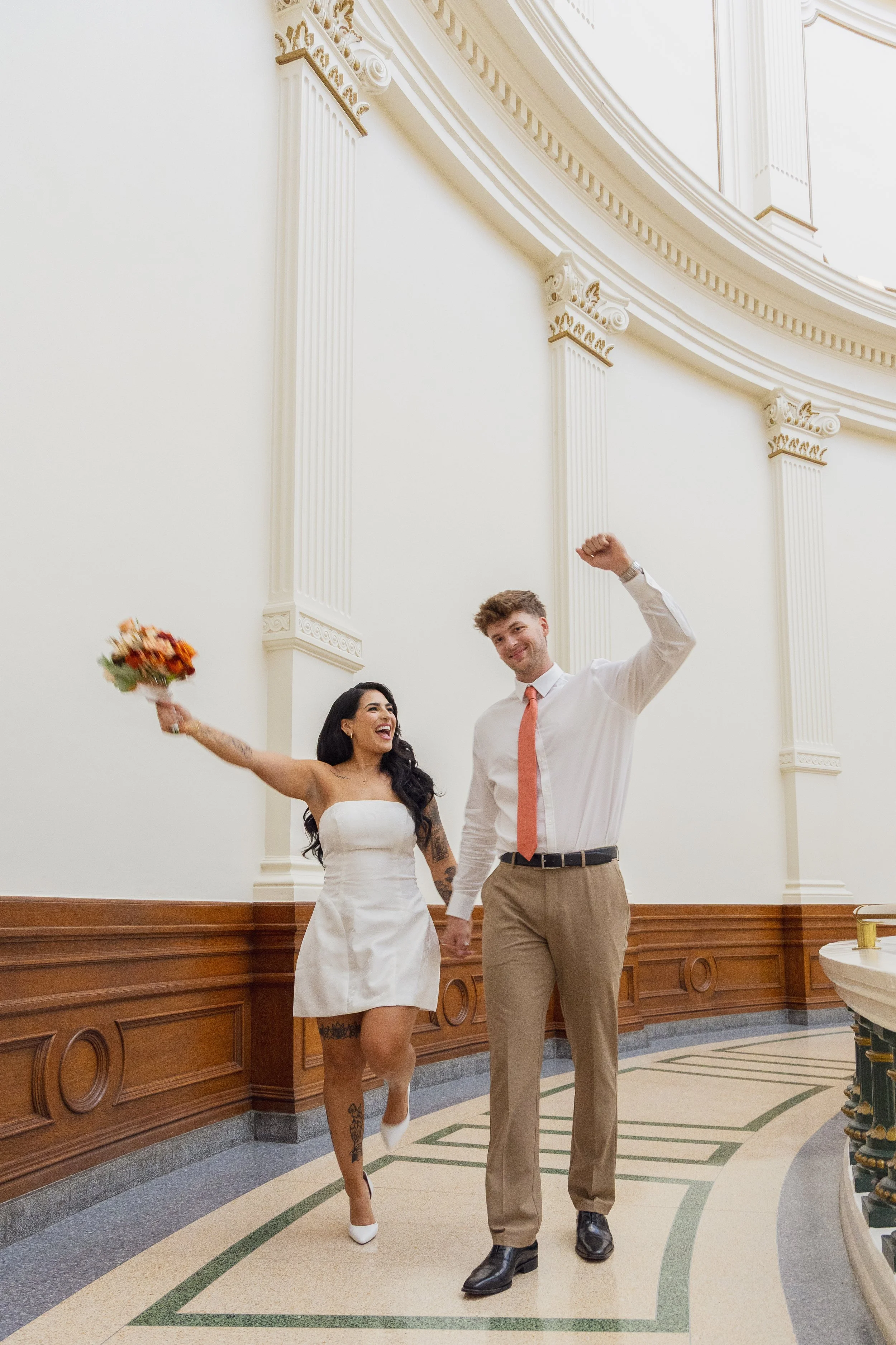 Young couple celebrates their courthouse wedding at the capitol of Texas building in Austin Texas 