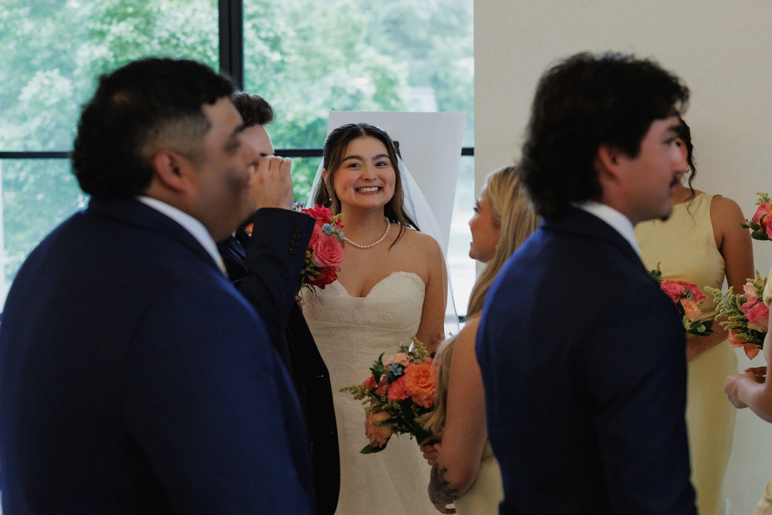 Bride smiles through crowd during the reception after her wedding ceremony at the Arlo, in Austin Texas