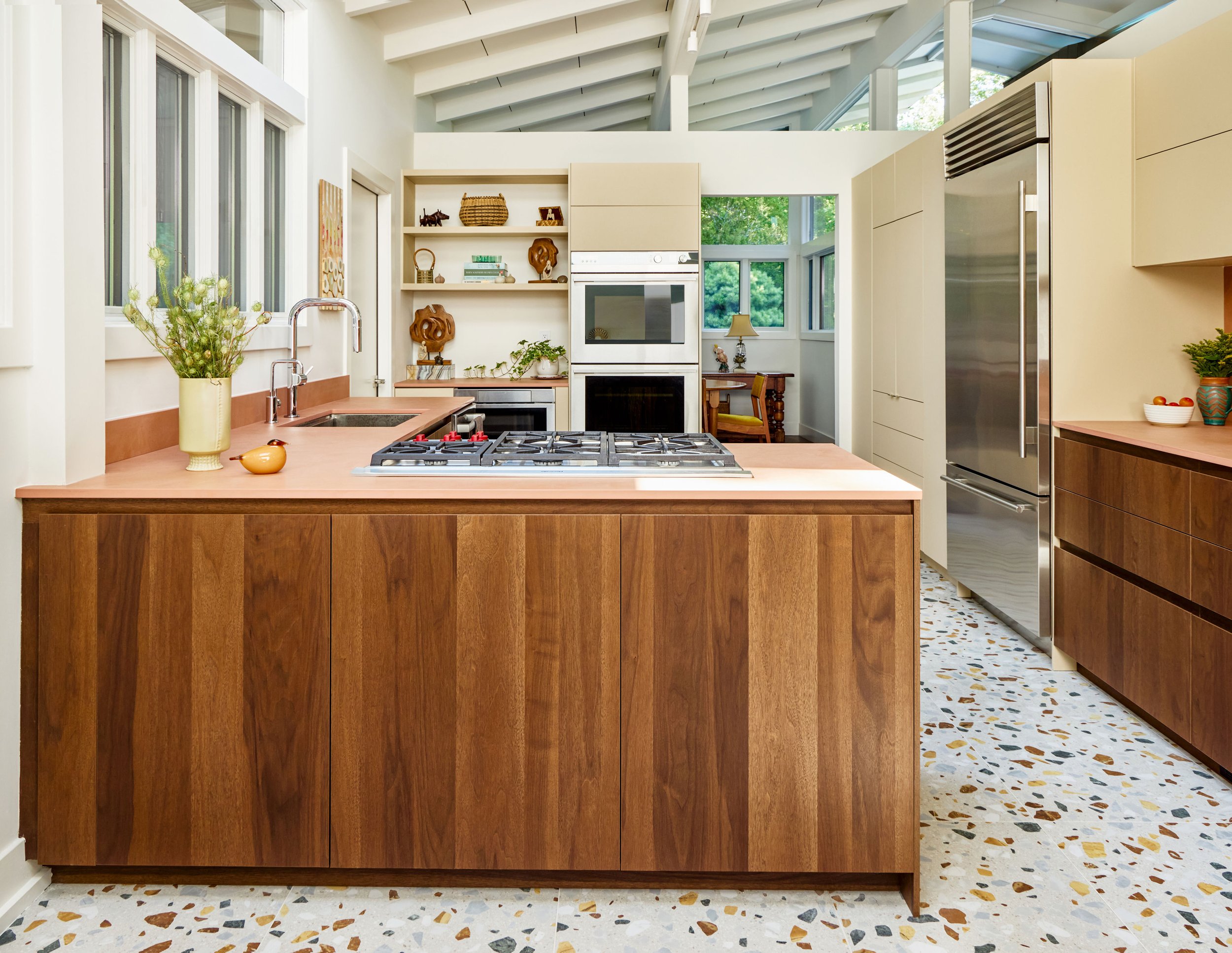 A midcentury kitchen with walnut cabinets and terracotta countertops