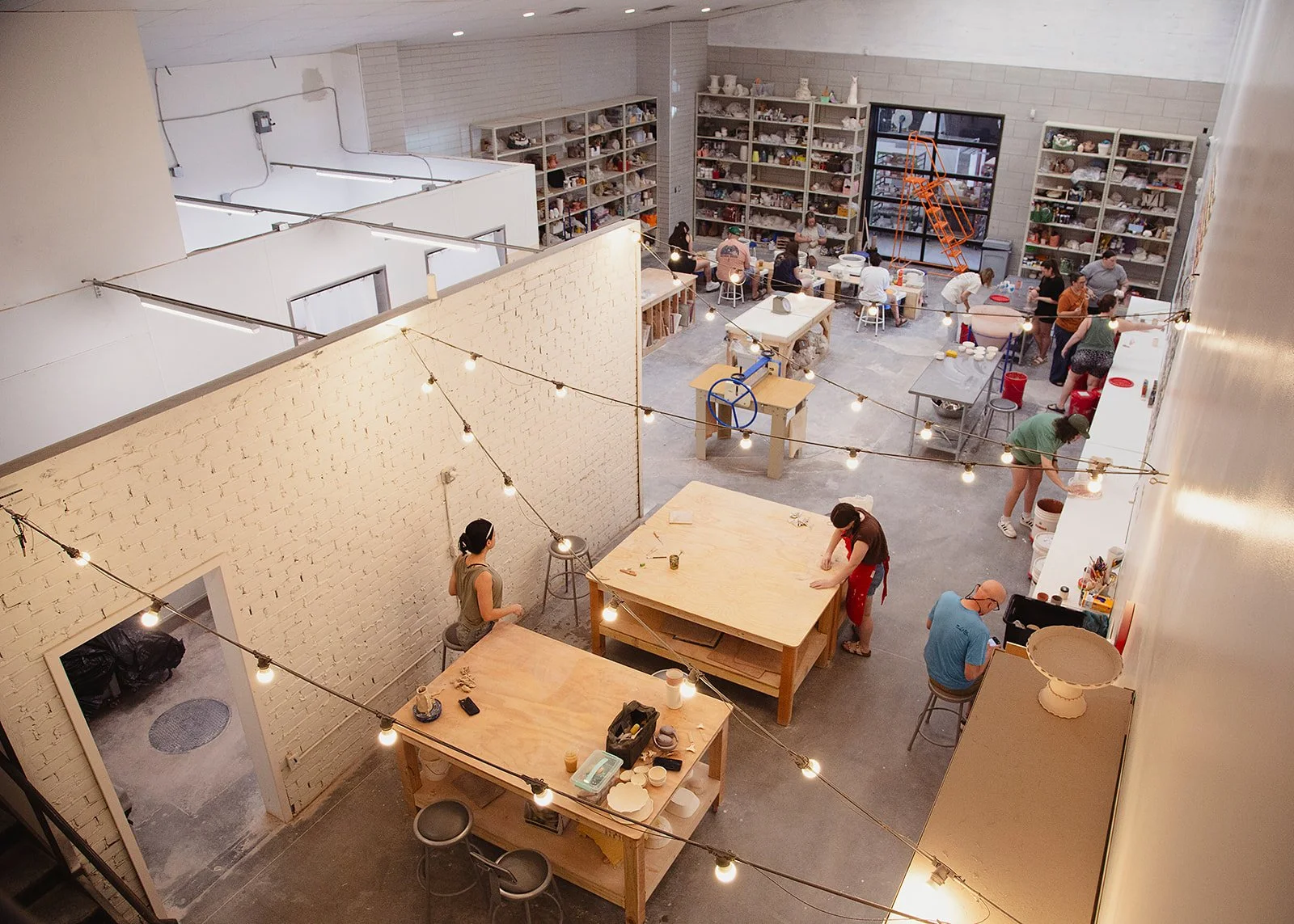 High-angle view of members working inside Still Life Ceramics studio in Richmond, VA, captured by Fairy Bread Photography.