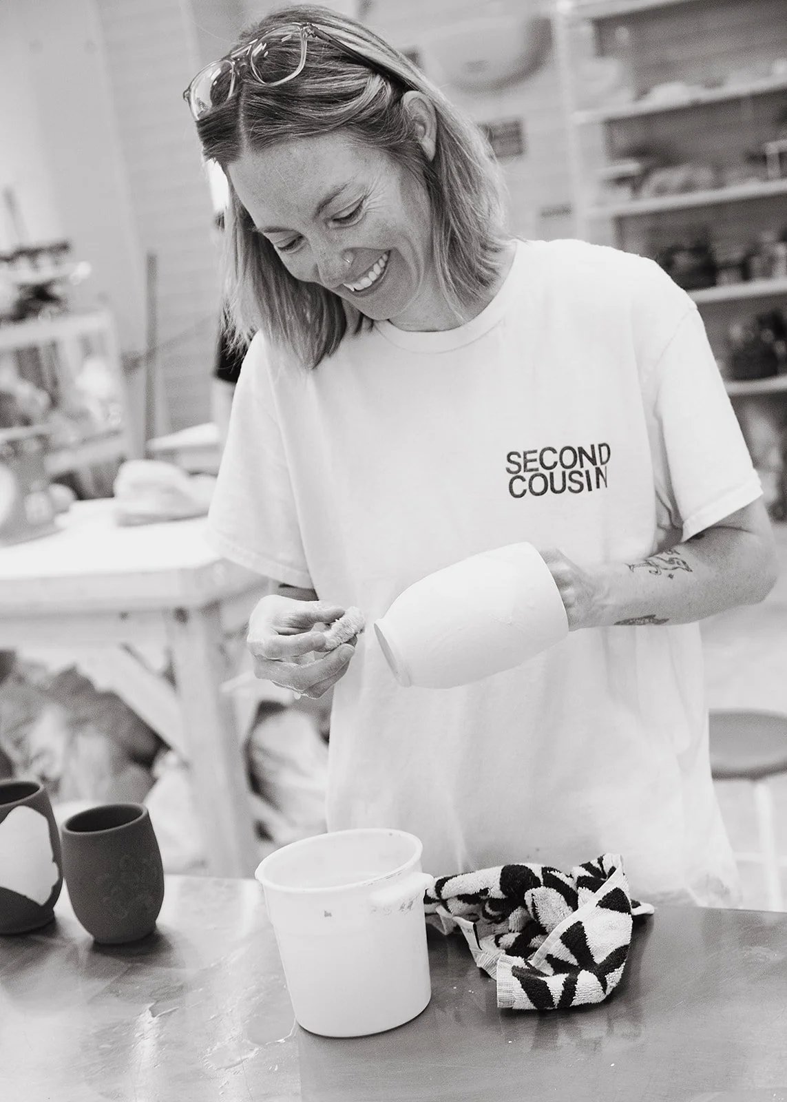 Candid portrait of a ceramic studio manager crafting pottery by hand in Richmond, VA, captured by Fairy Bread Photography.