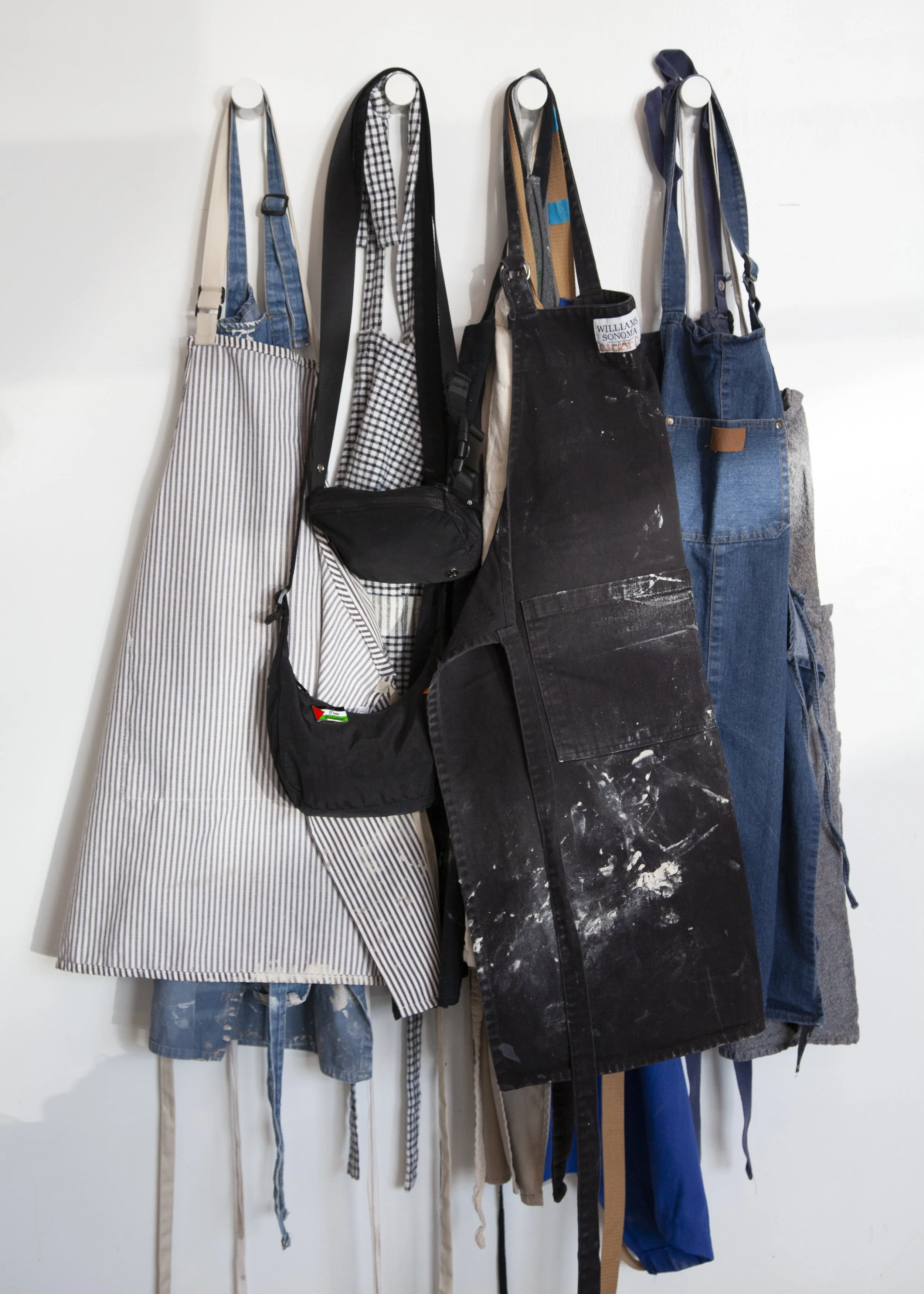 Aprons hung up in Still Life Ceramics photographed by Fairy Bread Photography in Richmond VA