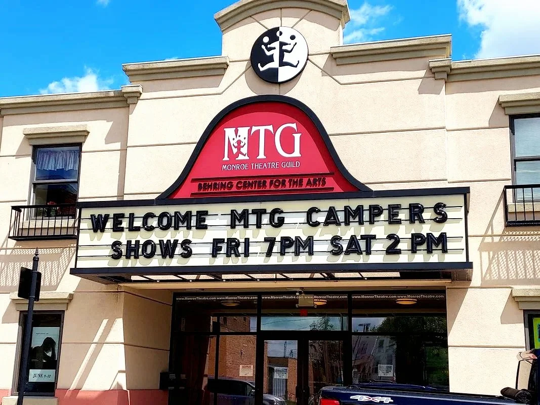 Sign at Monroe Theatre Guild welcoming MTG campers with showtimes of Friday at 7 PM and Saturday at 2 PM.