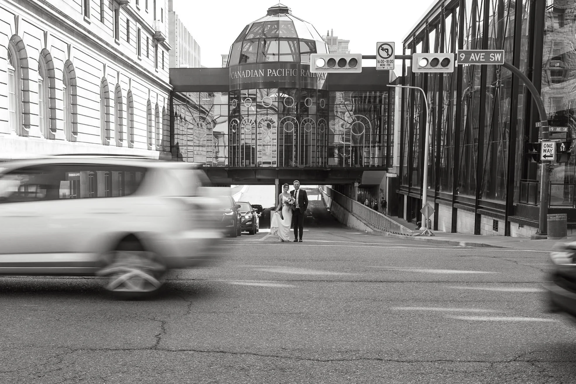 Black and white photo of bride and groom outside the Fairmont Palliser in Downtown Calgary 