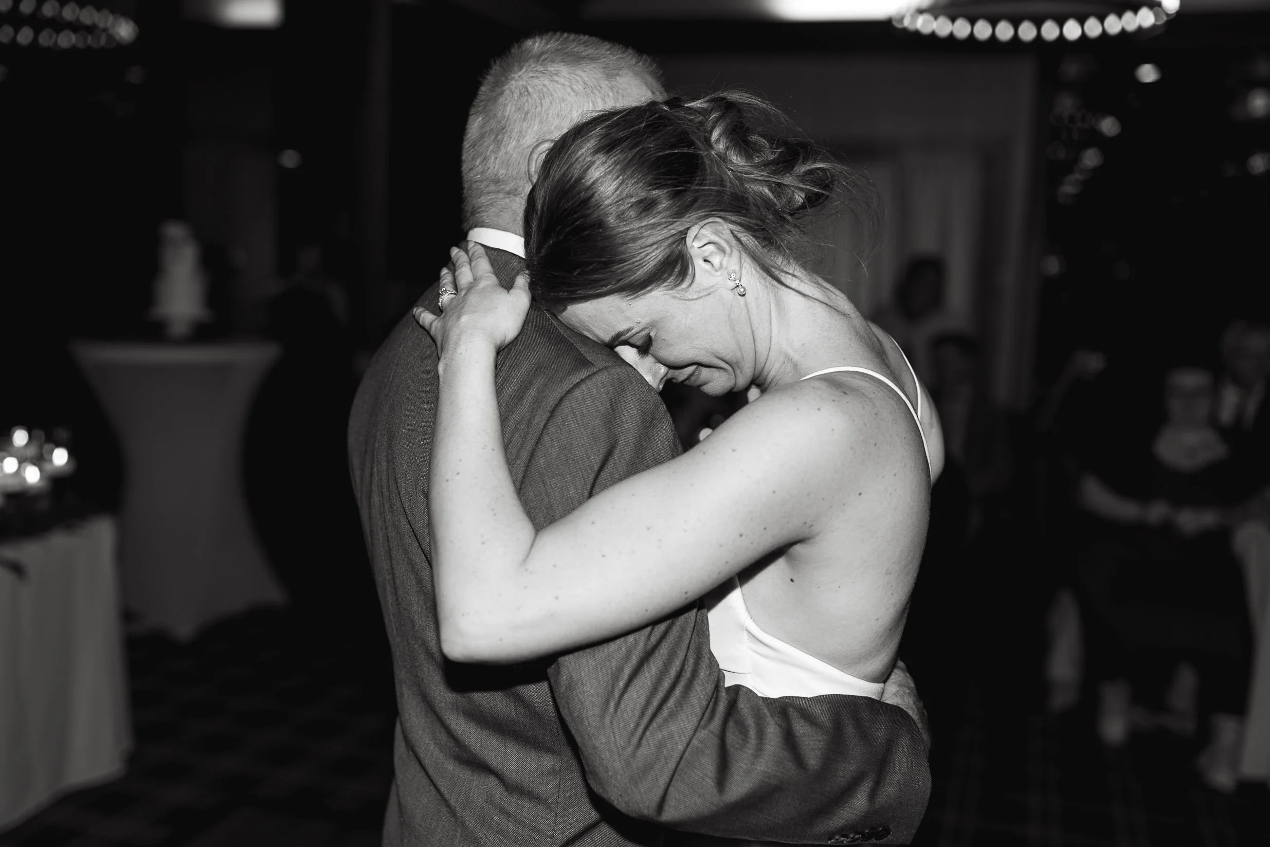 Emotional photo of bride crying while dancing with her dad at her wedding in Calgary 