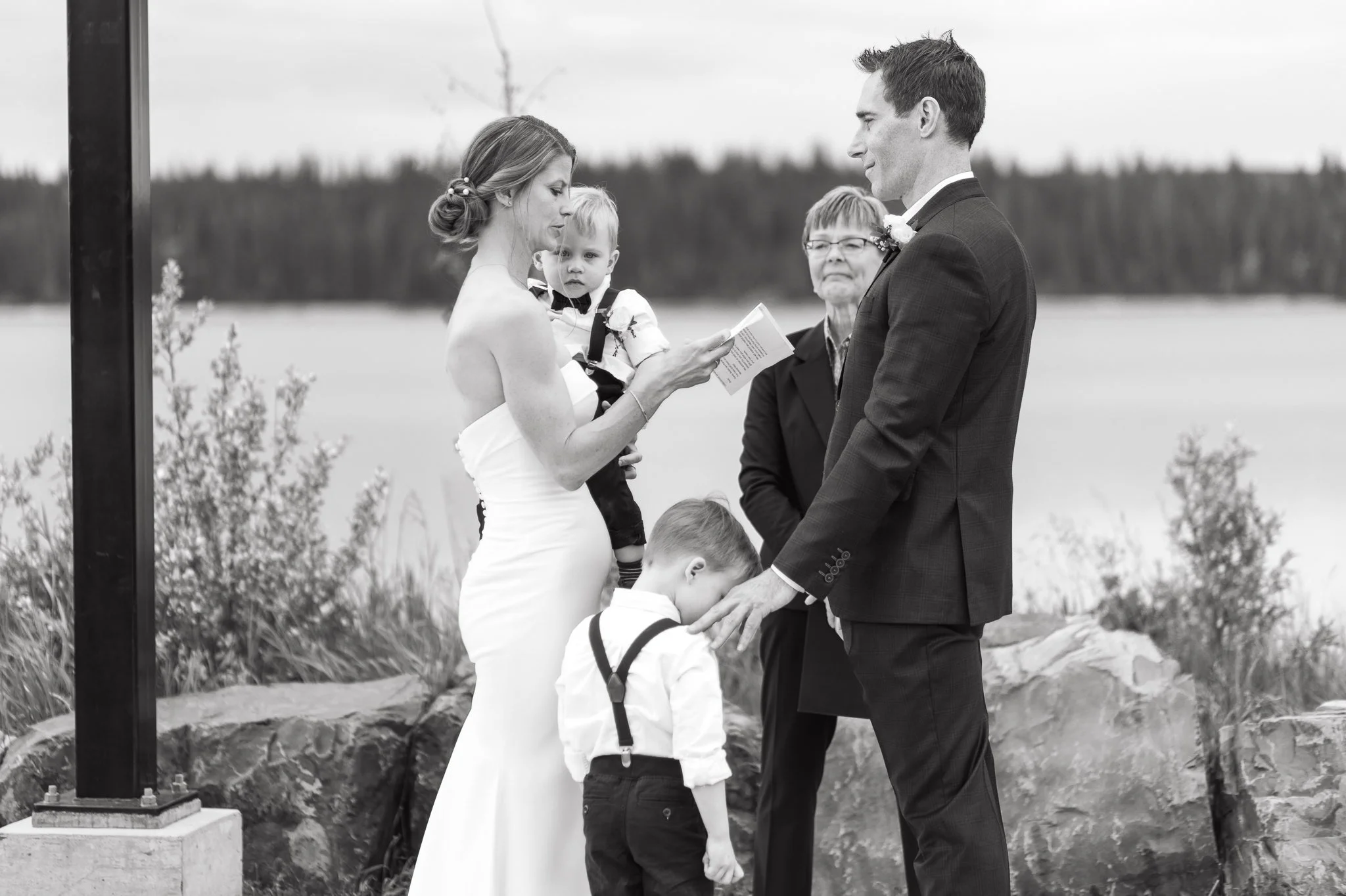 Couple exchanges wedding vows with their two young boys at intimate wedding in Calgary 