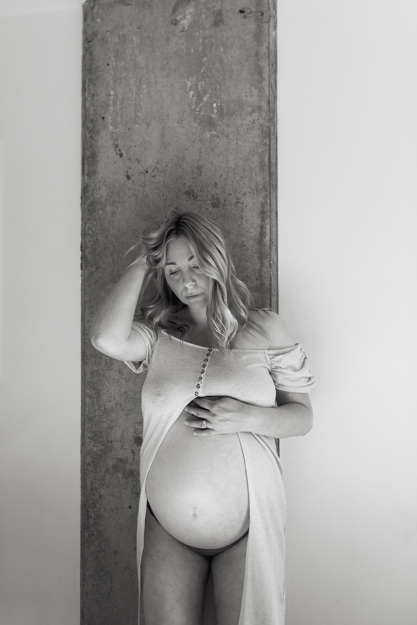 Black and white maternity photo with belly out 