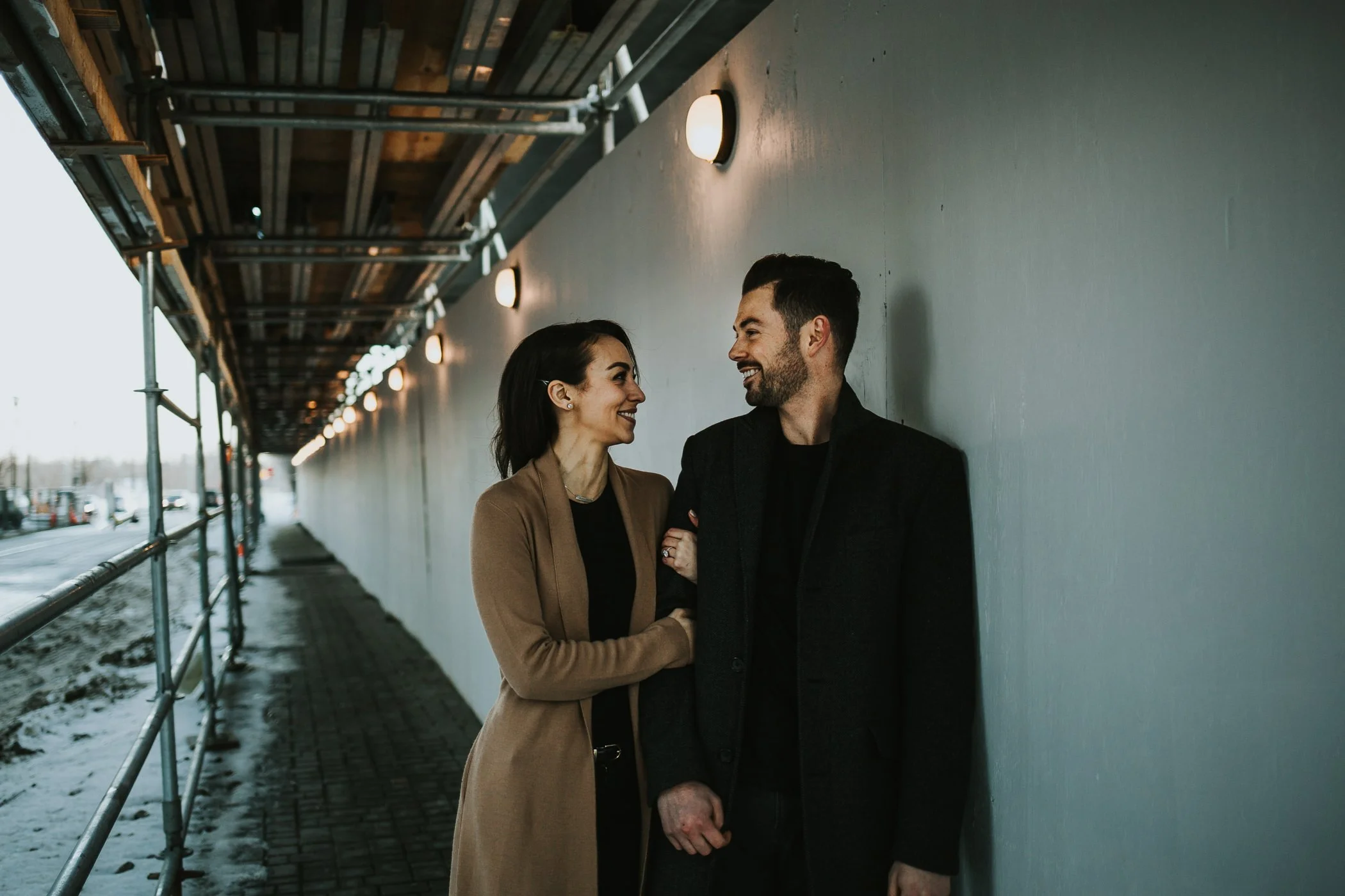 Couple standing under scaffolding in Calgary 