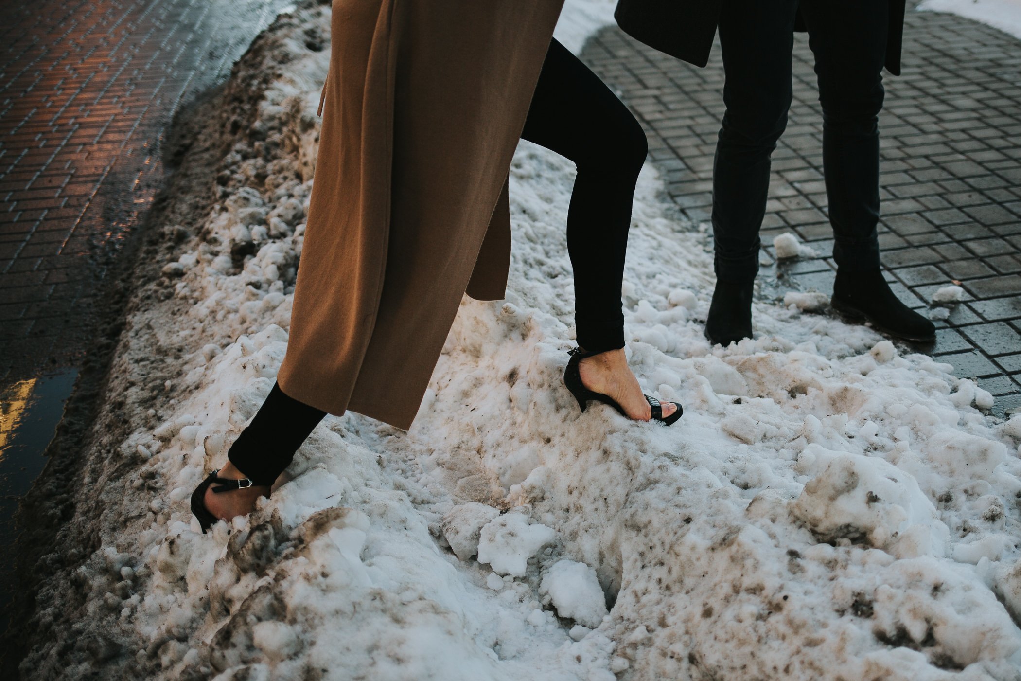 Girl walking through snowbank in high heels