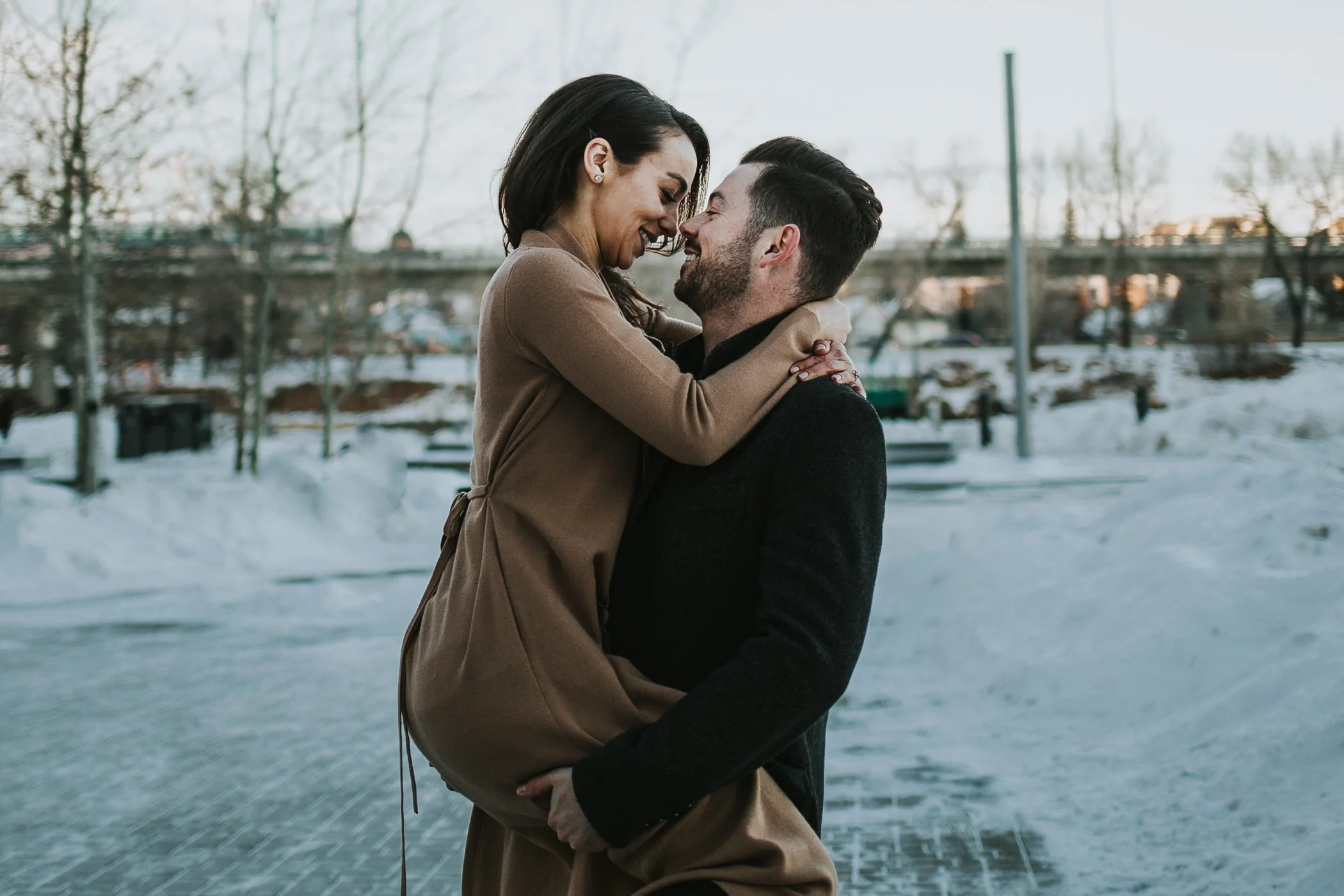 Couple snuggling nose to nose at their engagement shoot