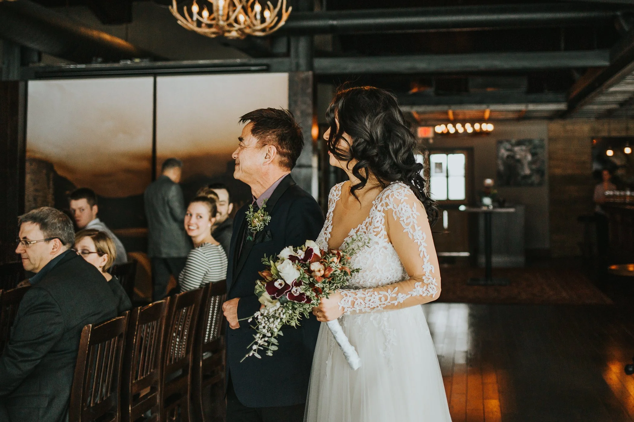 Bride and father walking down the aisle at Calgary Alberta winter wedding 