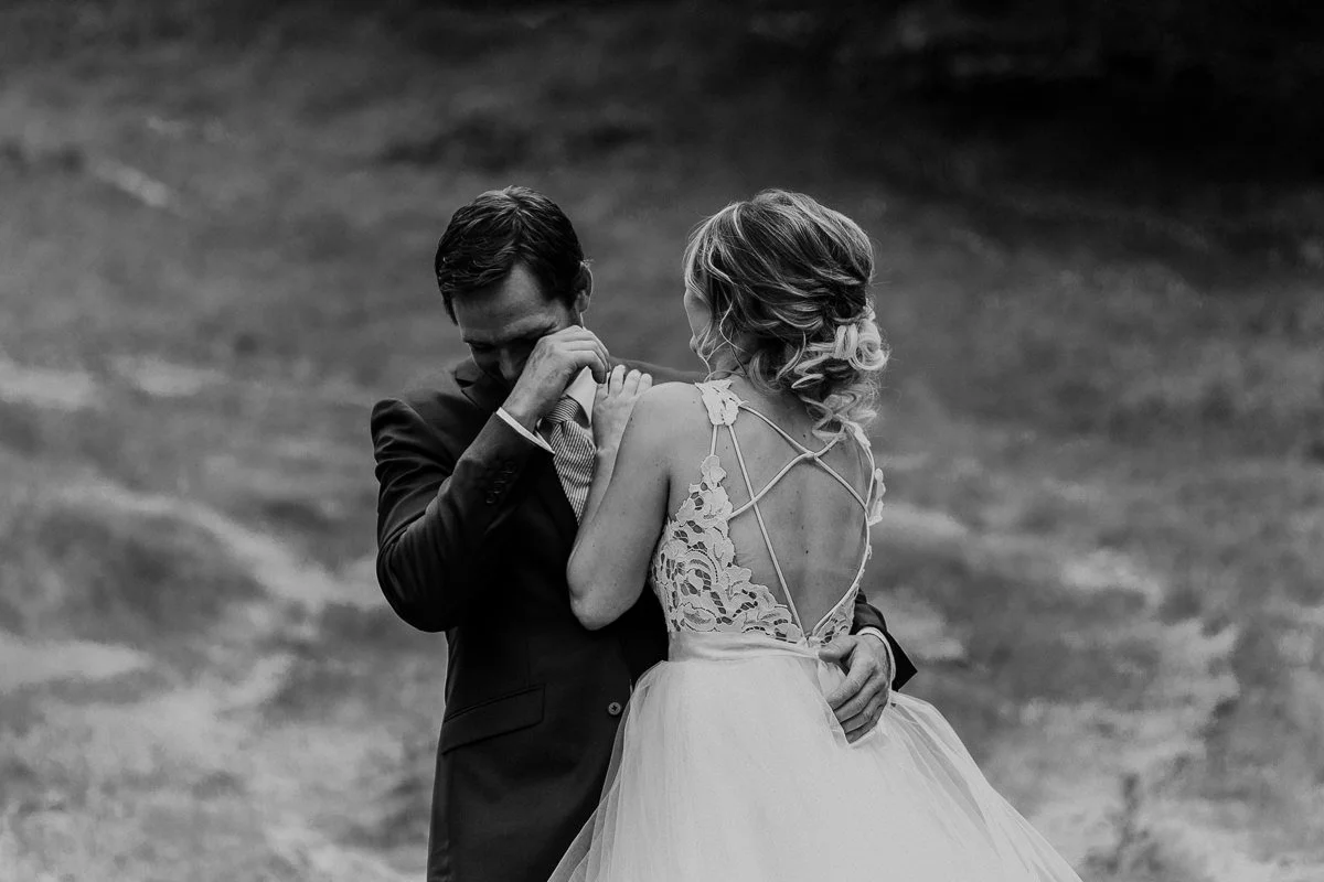 Groom crying black and white first look 
