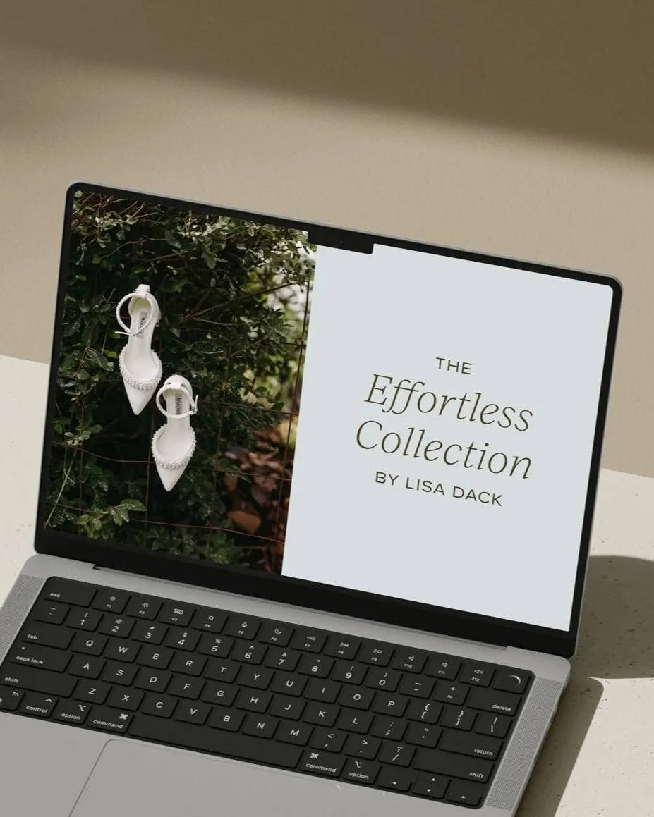A laptop displaying a book cover titled 'The Effortless Collection' by Lisa Dack and a photo of white shoes with pearl embellishments hanging on a bush.