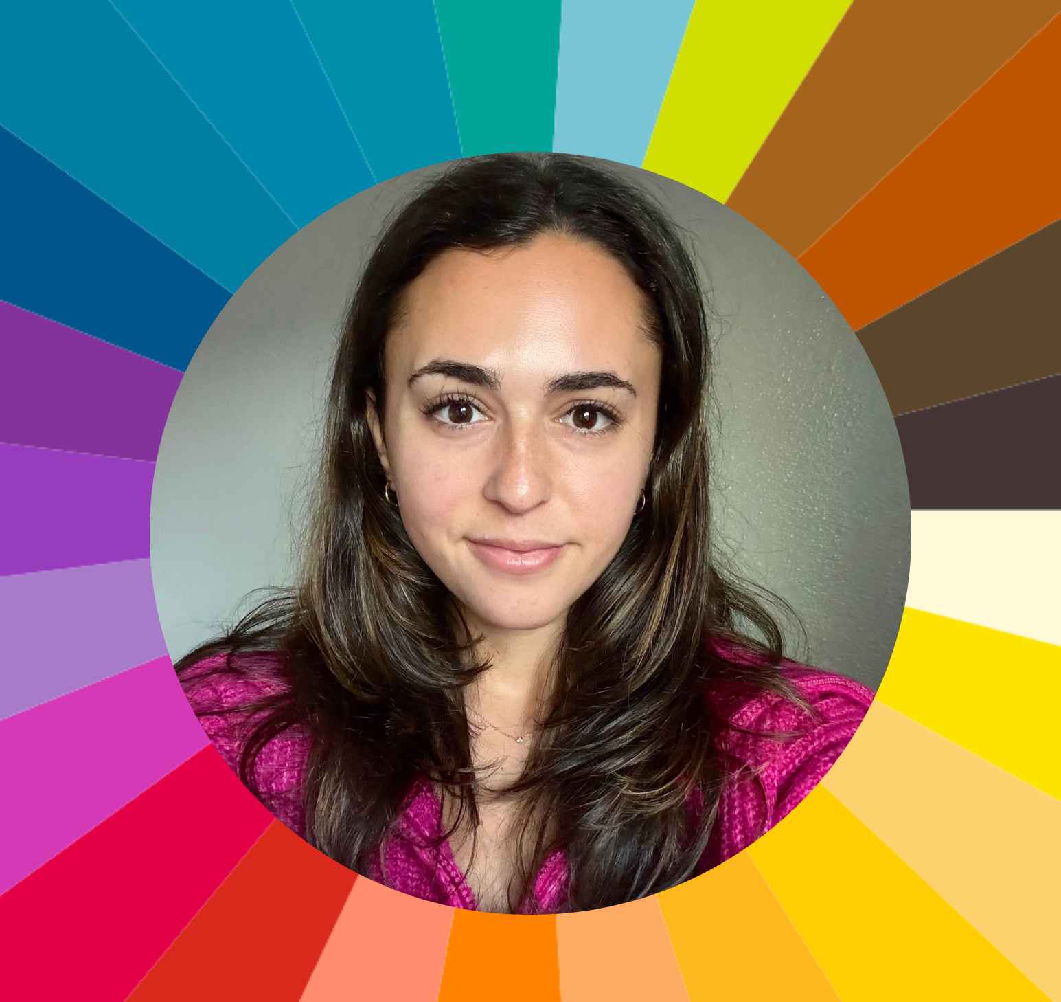 A woman with long brown hair, wearing a pink top, smiling in front of a gray background with a multicolored circular chart behind her.