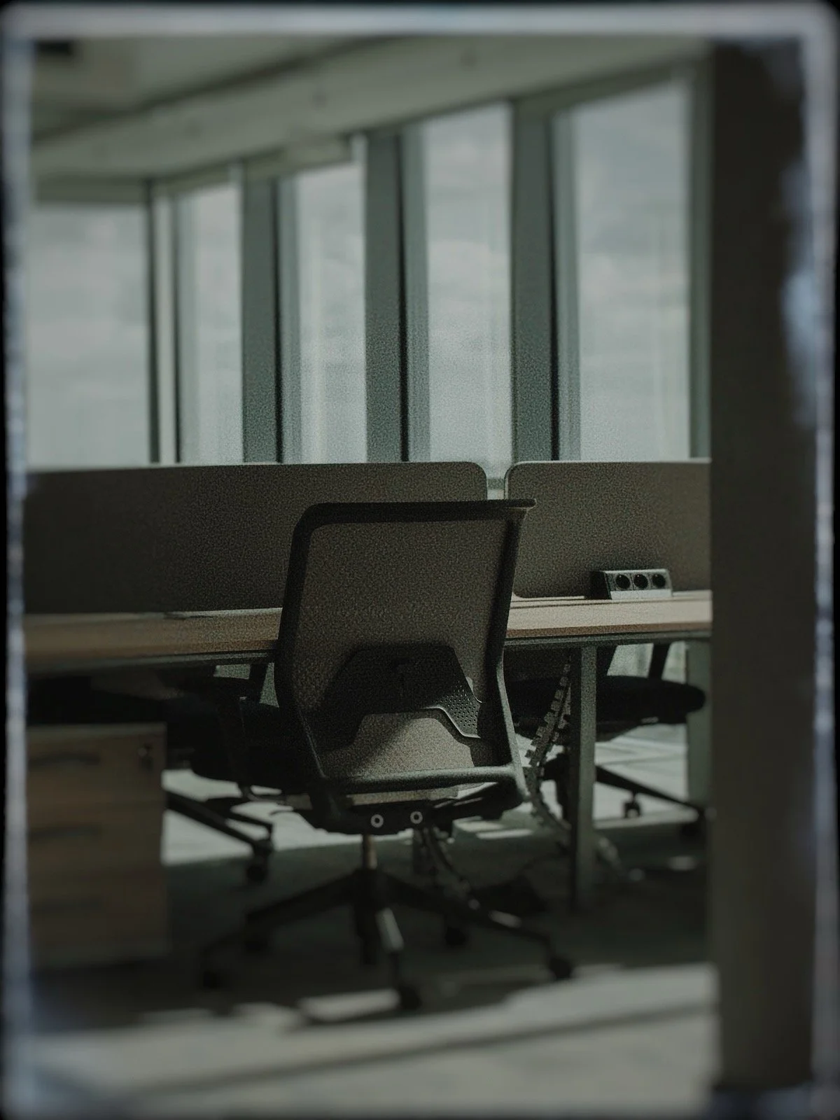 quiet office workspace with empty chair and low activity team environment