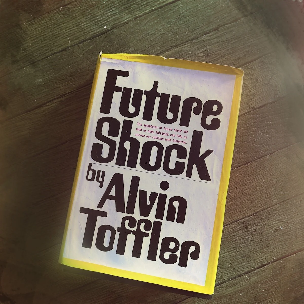 Worn hardcover copy of Future Shock by Alvin Toffler on a textured surface