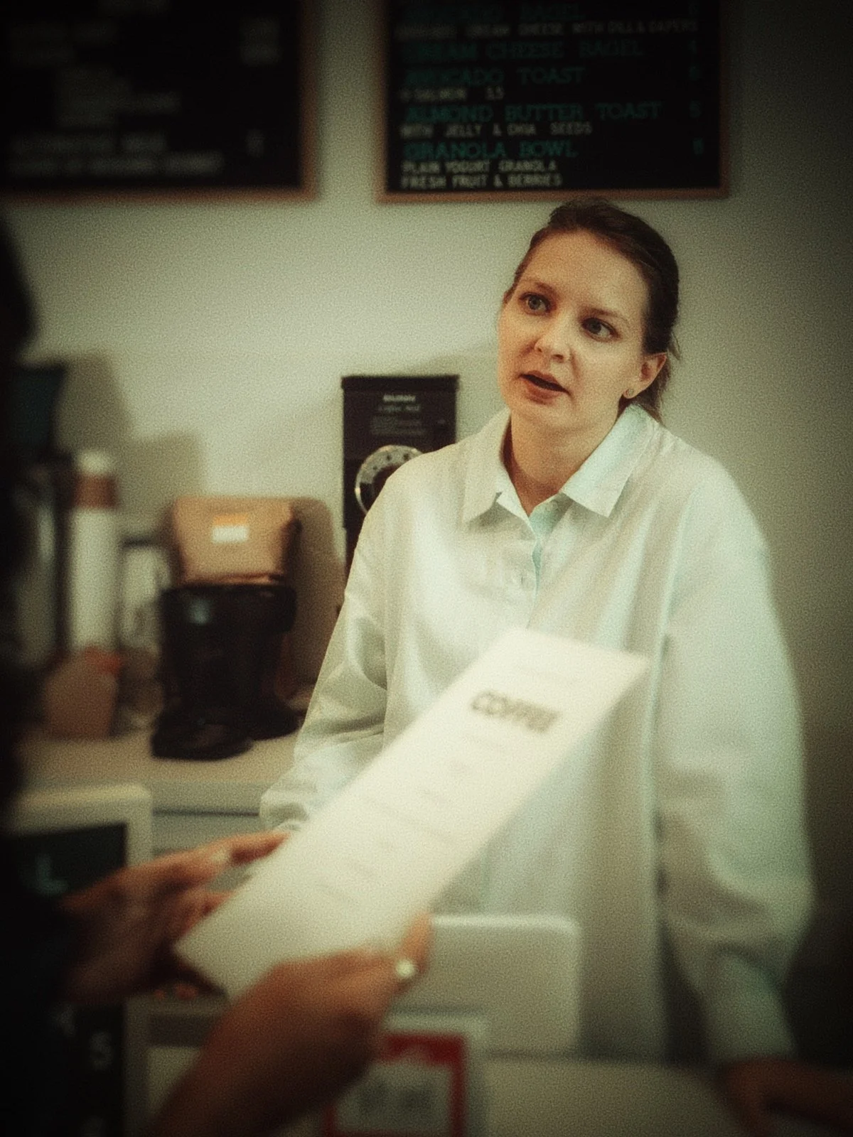 disengaged cashier at checkout line reflecting workplace culture and operational conditions