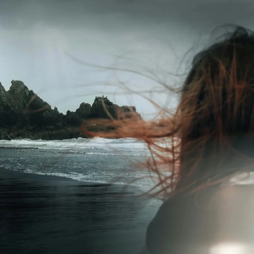 Person standing on a dark, windswept coast facing the ocean, representing sovereignty, uncertainty, and the founder’s responsibility to govern what AI now makes possible.