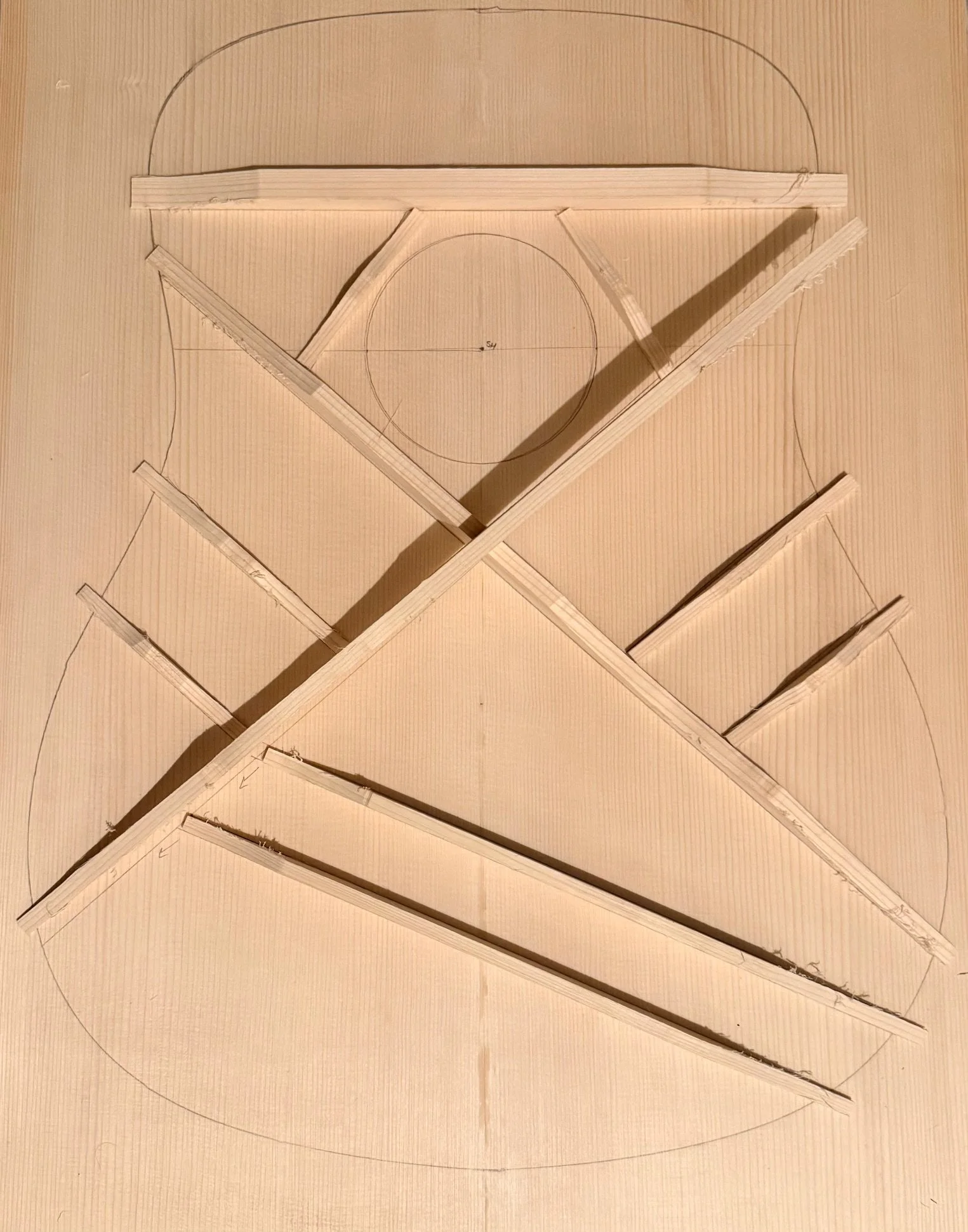 Drawing of a basketball court layout with wooden pieces and lines representing the court's dimensions and features.