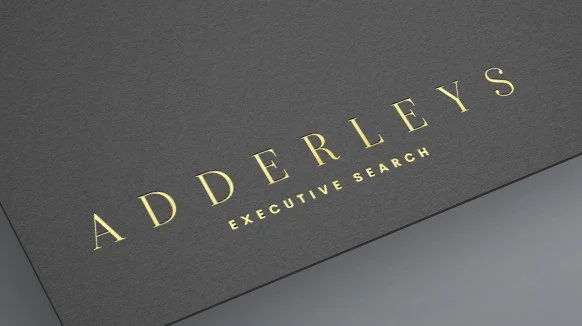 Business card design with 'Adderleys Executive Search' text in elegant font on dark background.