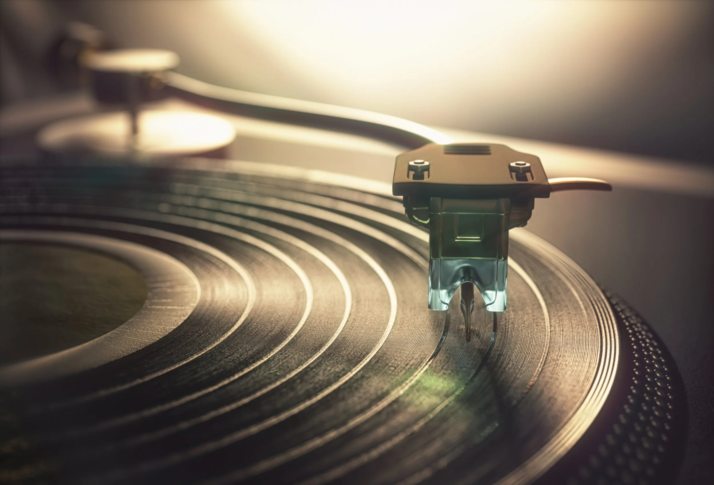 Close-up of a vinyl record being played by a turntable needle arm.