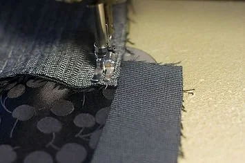 Close-up of fabric being sewn with a sewing machine
