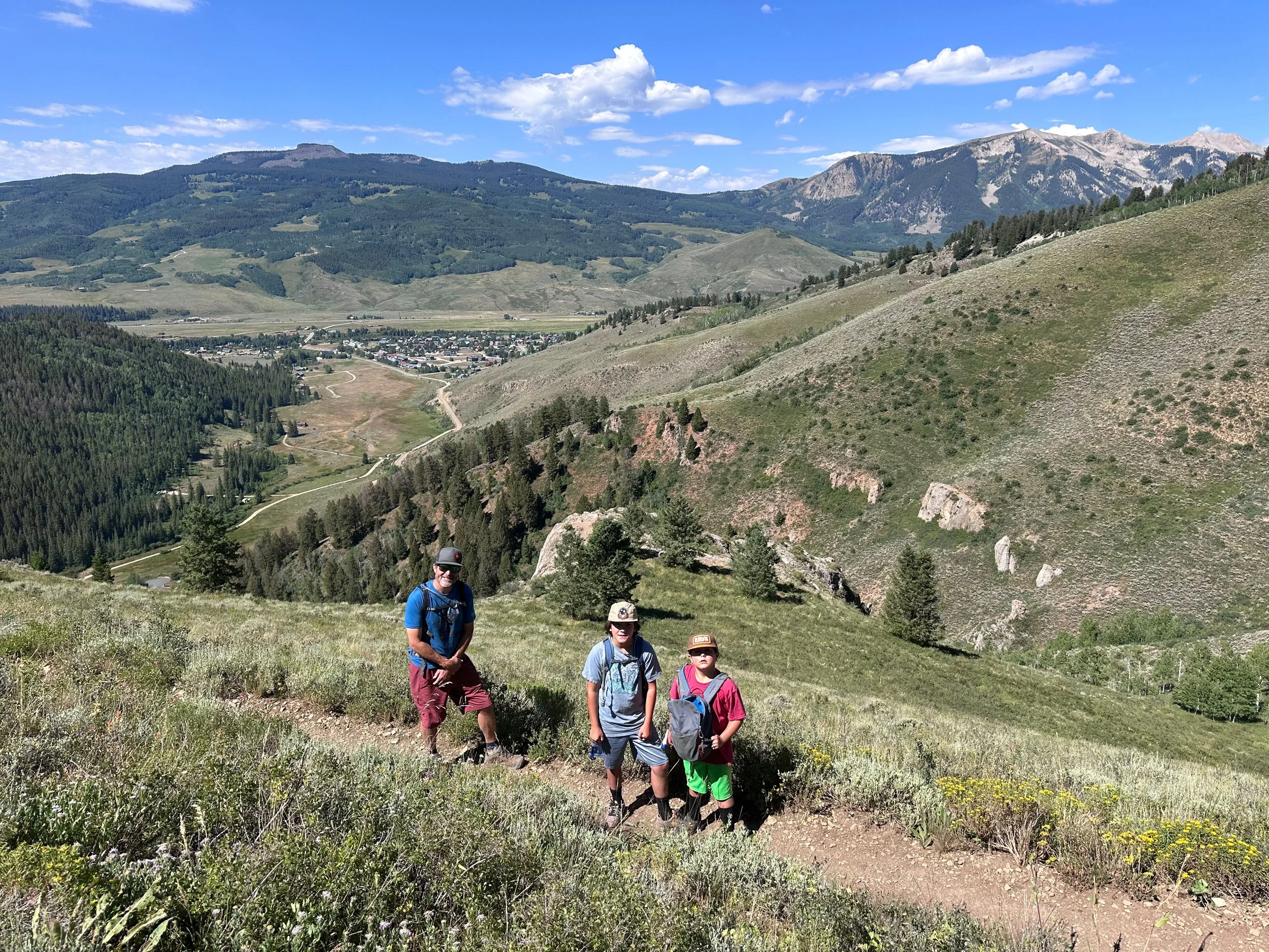 Family hiking above Crested Butte, Colorado, representing our personalized adventure concierge and custom trip planning services