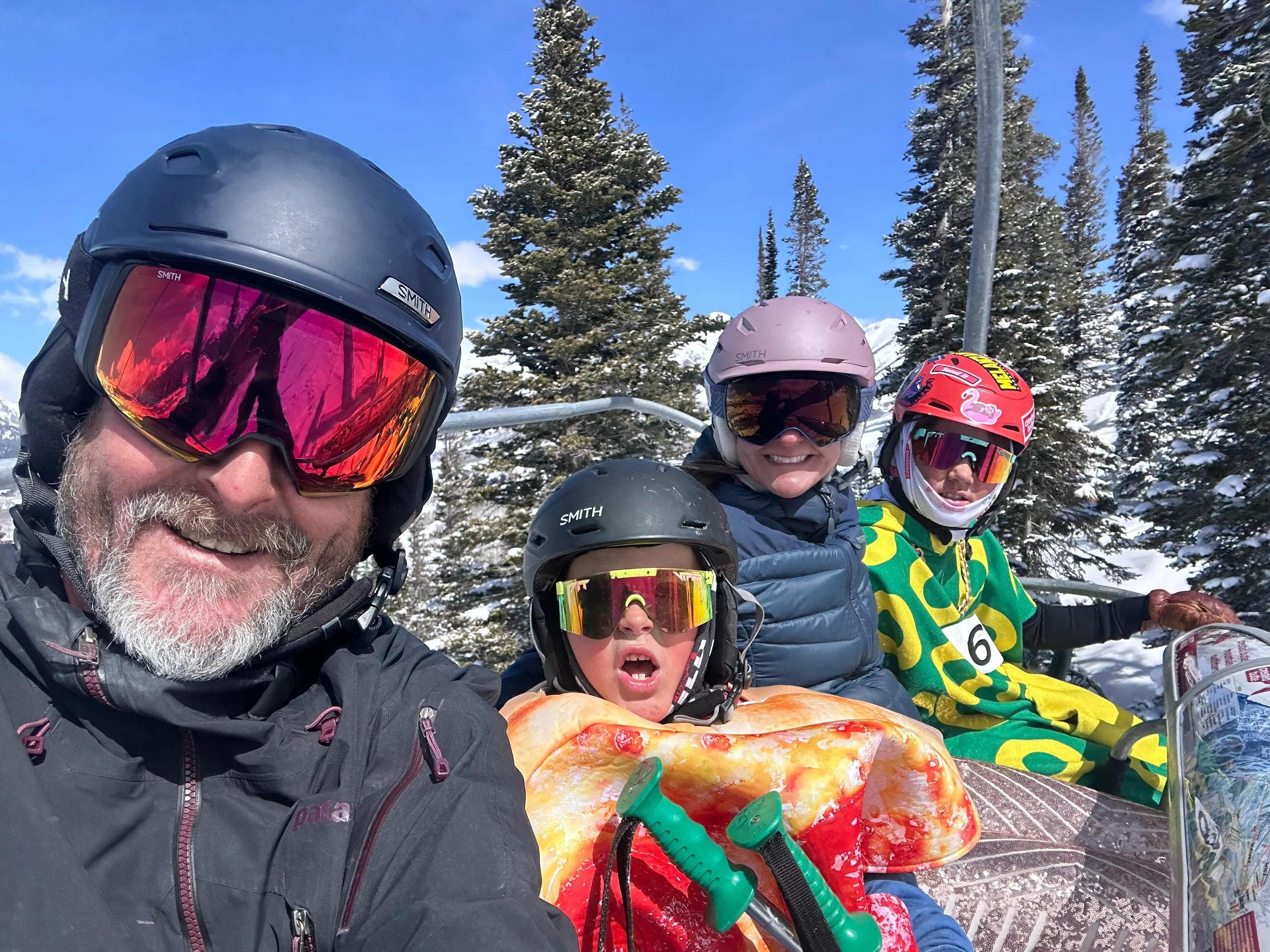 Jay Whitacre and family on a ski lift in Crested Butte, representing local expertise, community connection, and the warm, personal approach behind Adventure Management