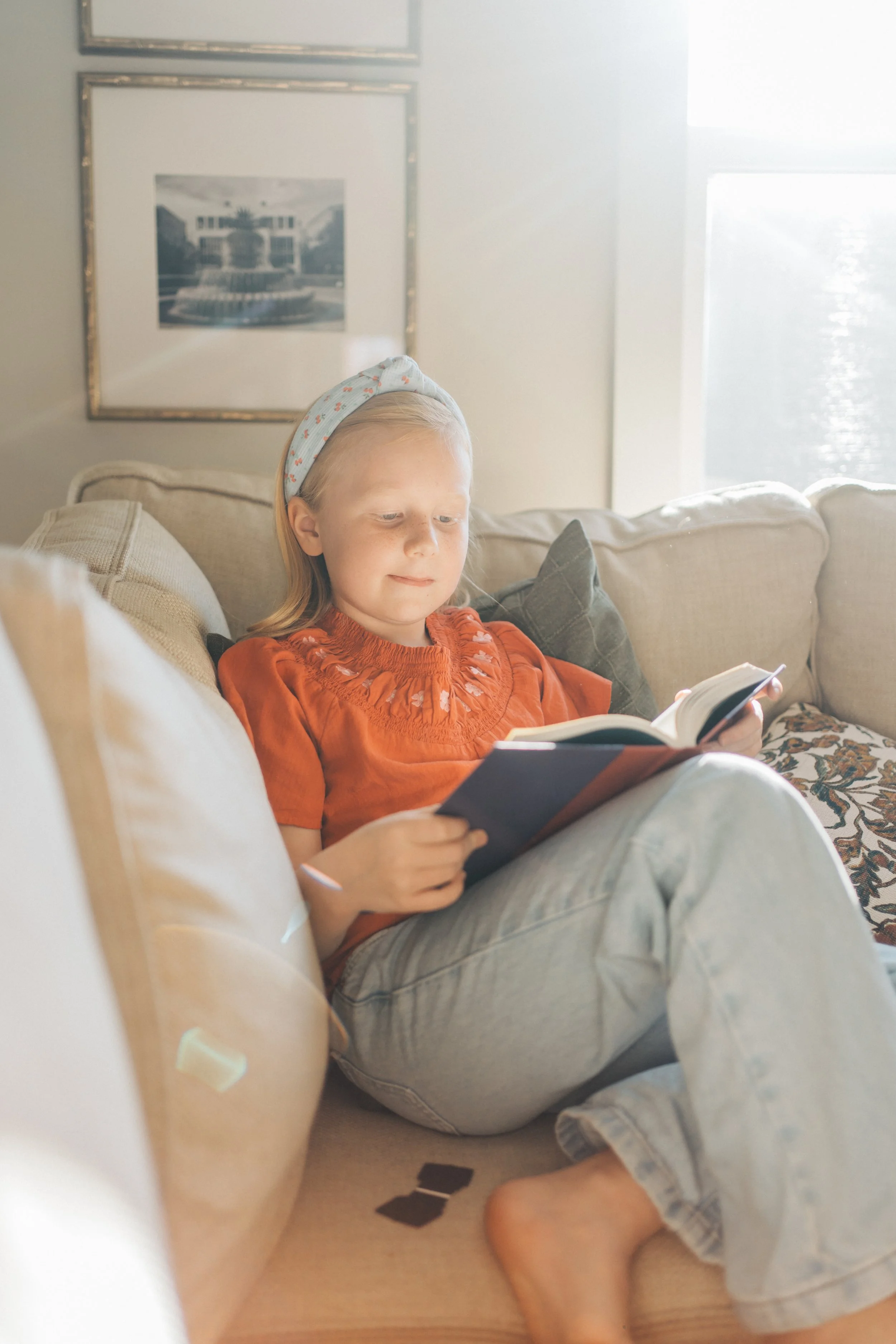 young girl reading harry potter in raleigh north carolina living room family photography