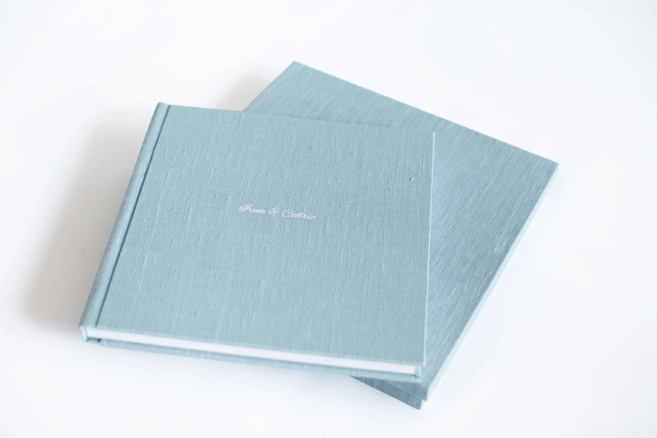 Pale blue heirloom photo albums printed on professional Fuji DPII paper, showcasing fine art family photography products by Autumn Brooke Photography.