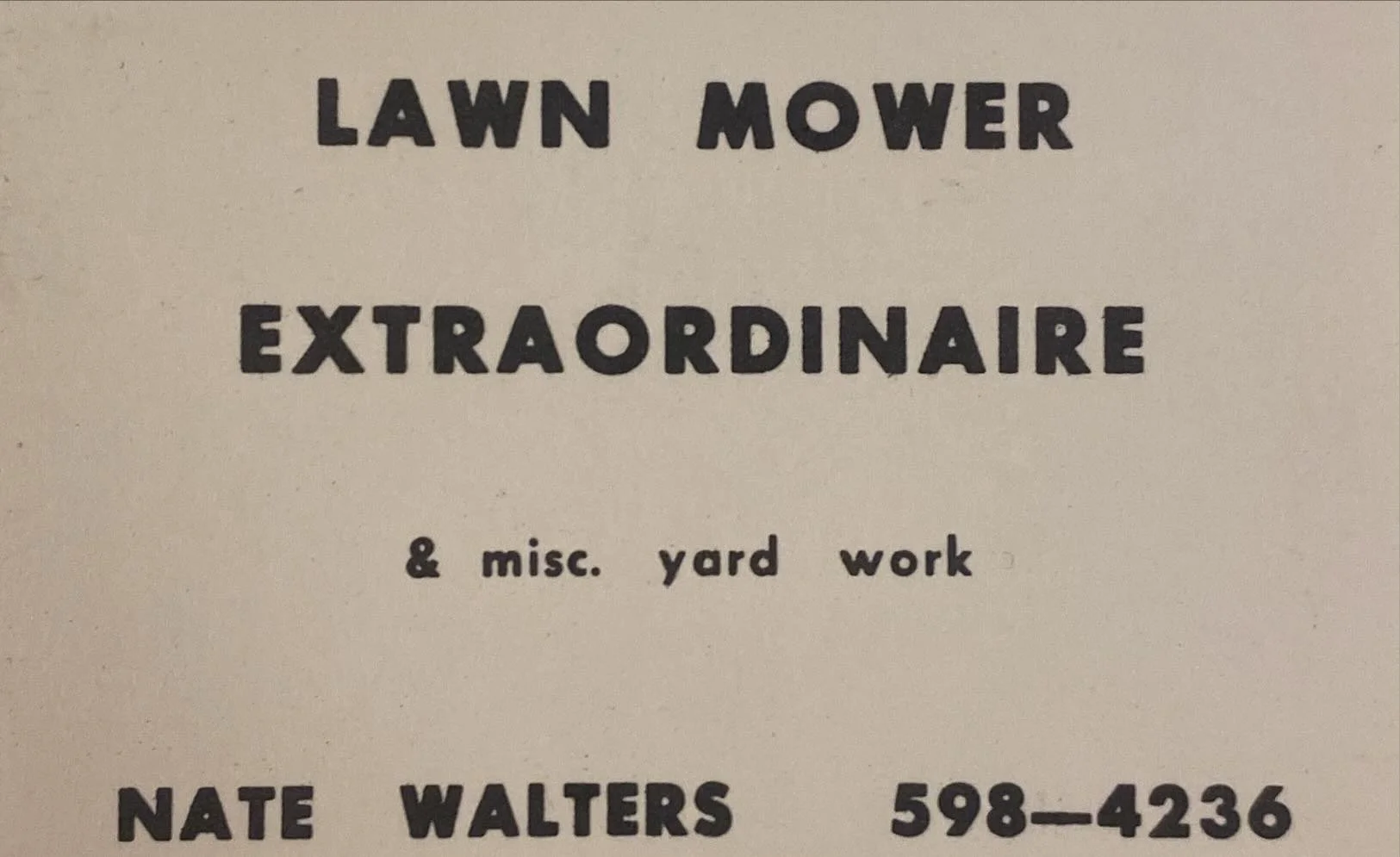 A sign for lawn mower and yard work services, featuring bold text with the name Nate Walters and phone number 598-4236.