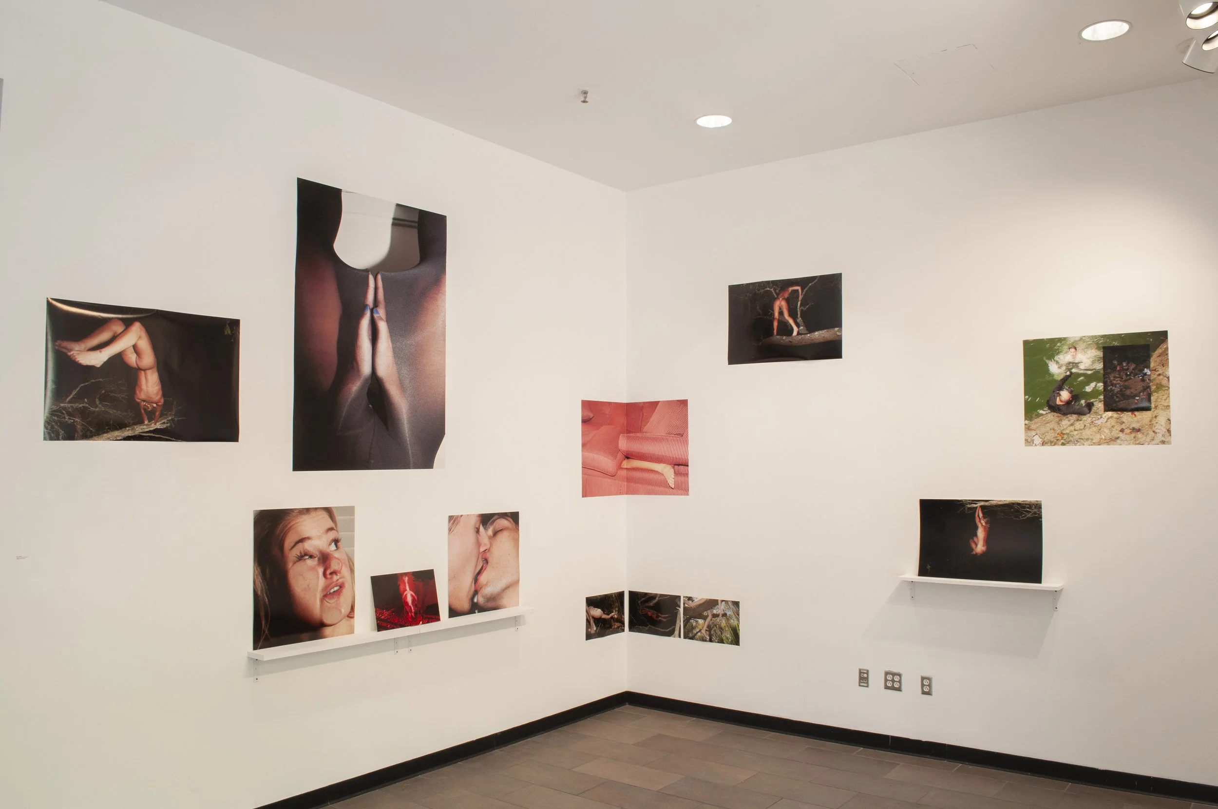 Gallery wall with various photographs of people in different poses and scenes, including close-ups and outdoor settings.
