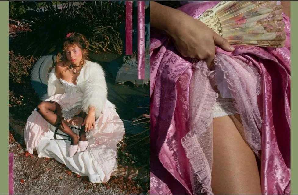 A woman dressed in vintage-style clothing, including a white faux fur coat, sitting outdoors on a white cloth. She has curly hair, wears heels, and is surrounded by plants. The right side of the image shows a close-up of pink satin fabric and a person's hand holding a fan, revealing lace and a glimpse of her thigh.