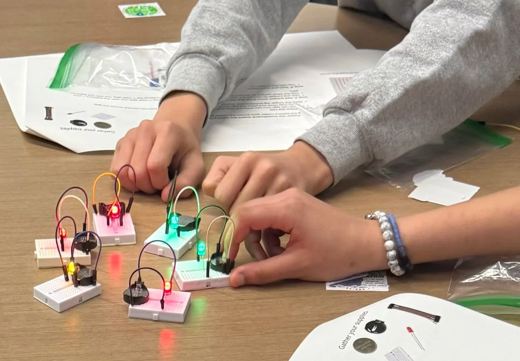 Students experimenting with LED circuits during the Girls in Tech challenge—applying creativity, teamwork, and a whole lot of persistence.