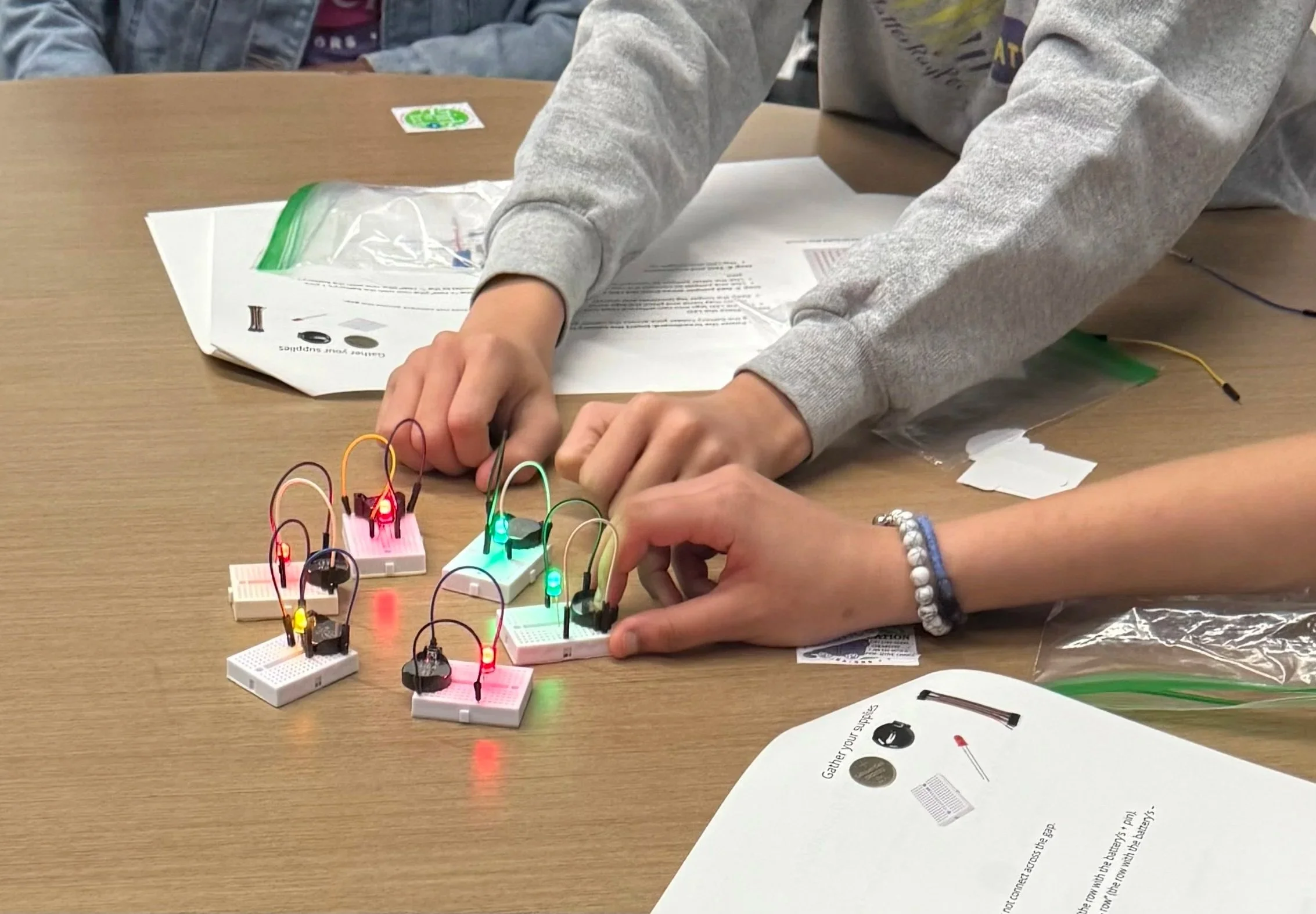 Students experimenting with LED circuits during the Girls in Tech challenge—applying creativity, teamwork, and a whole lot of persistence.