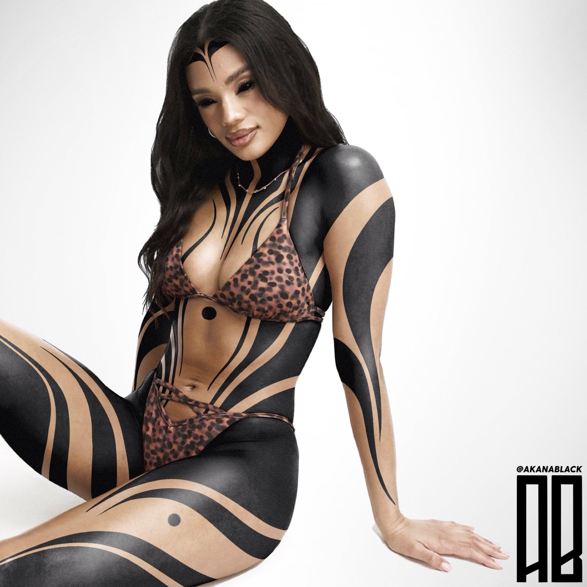 A woman with black hair and tattoos wearing leopard print lingerie, sitting against a plain white background.